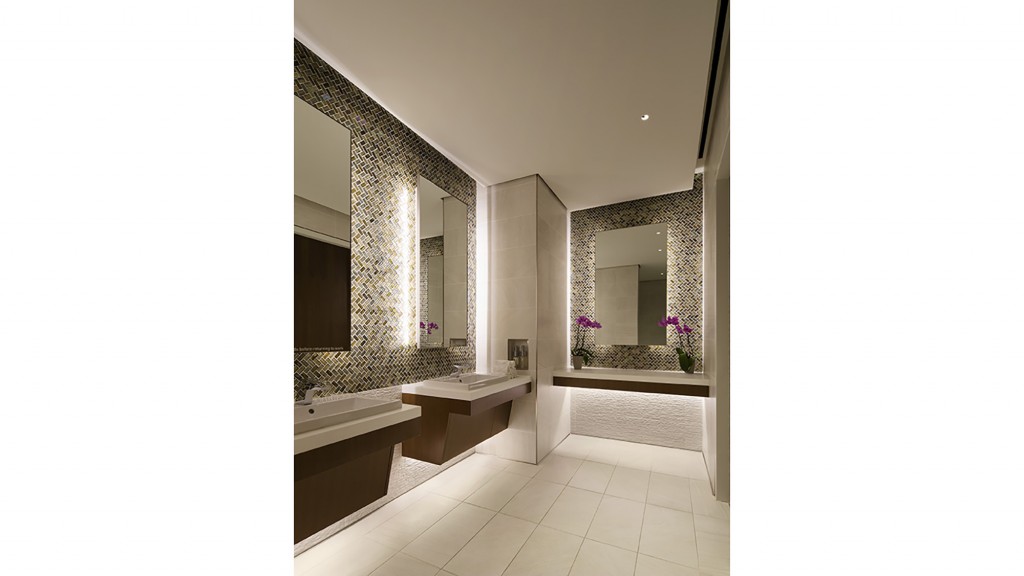 A bathroom with a large mirror.